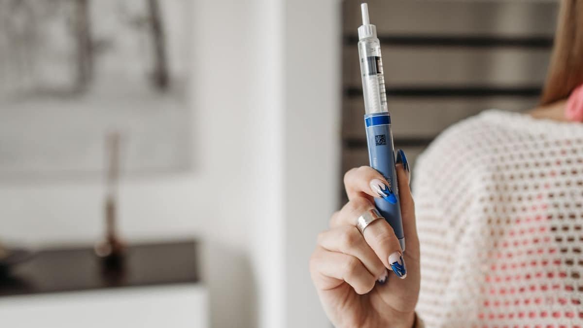 Woman holding a GLP-1 injection pen