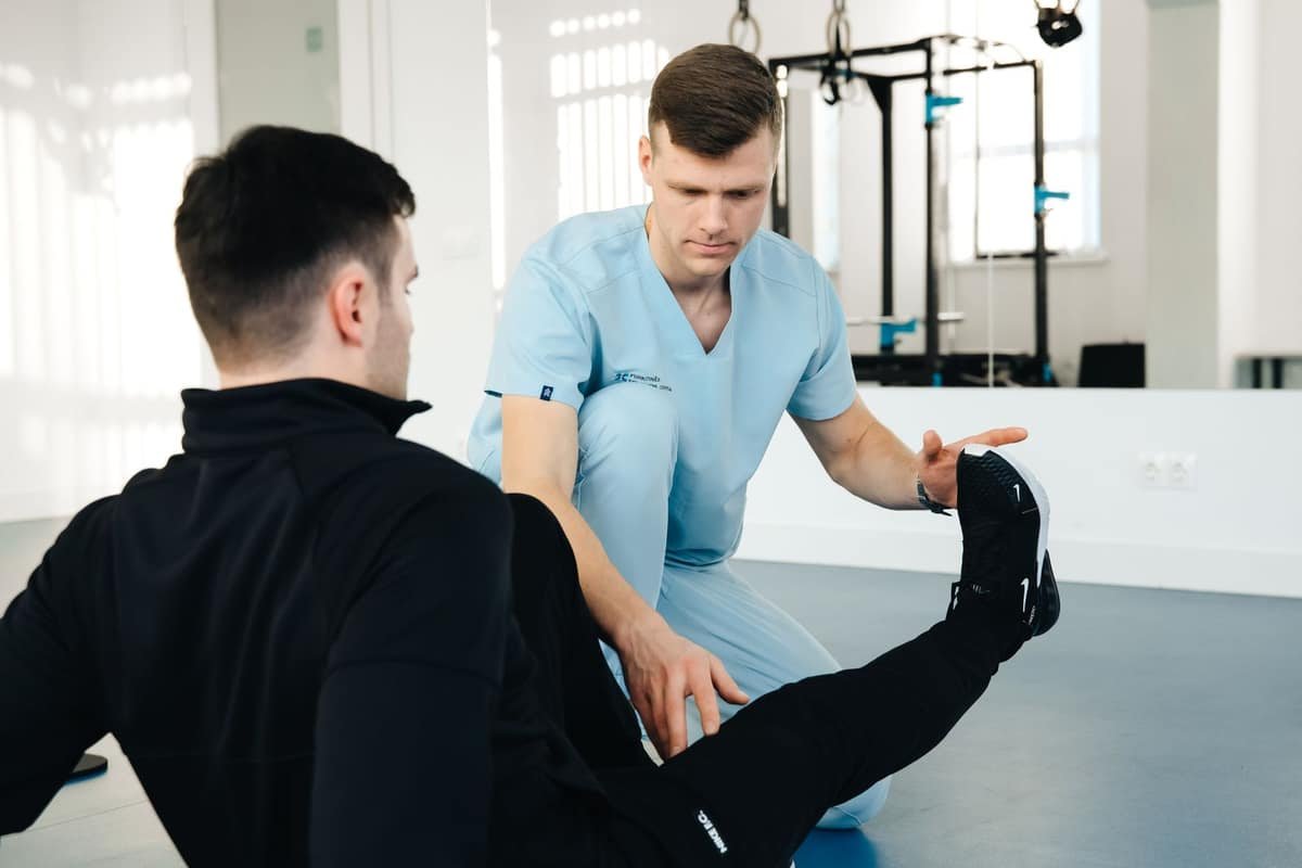 Physical therapist examining a patient’s leg and foot
